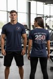 One Rep Above navy blue athletic t-shirt with 250 Years of Strength graphic on back, worn by a man and woman in a gym.